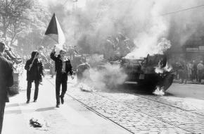 Tsjecho-Slowaken met hun vlag naast een brandende tank in Praag in 1968